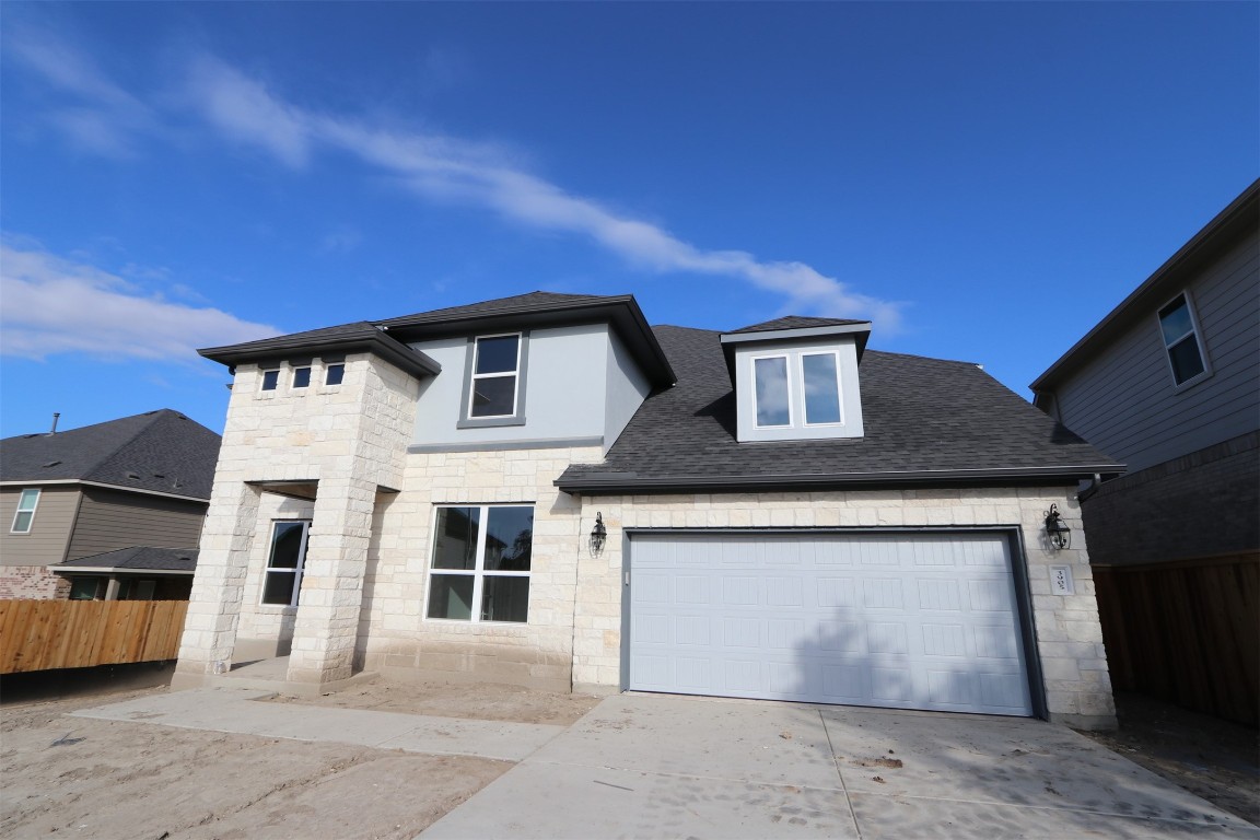 a front view of a house with a garage