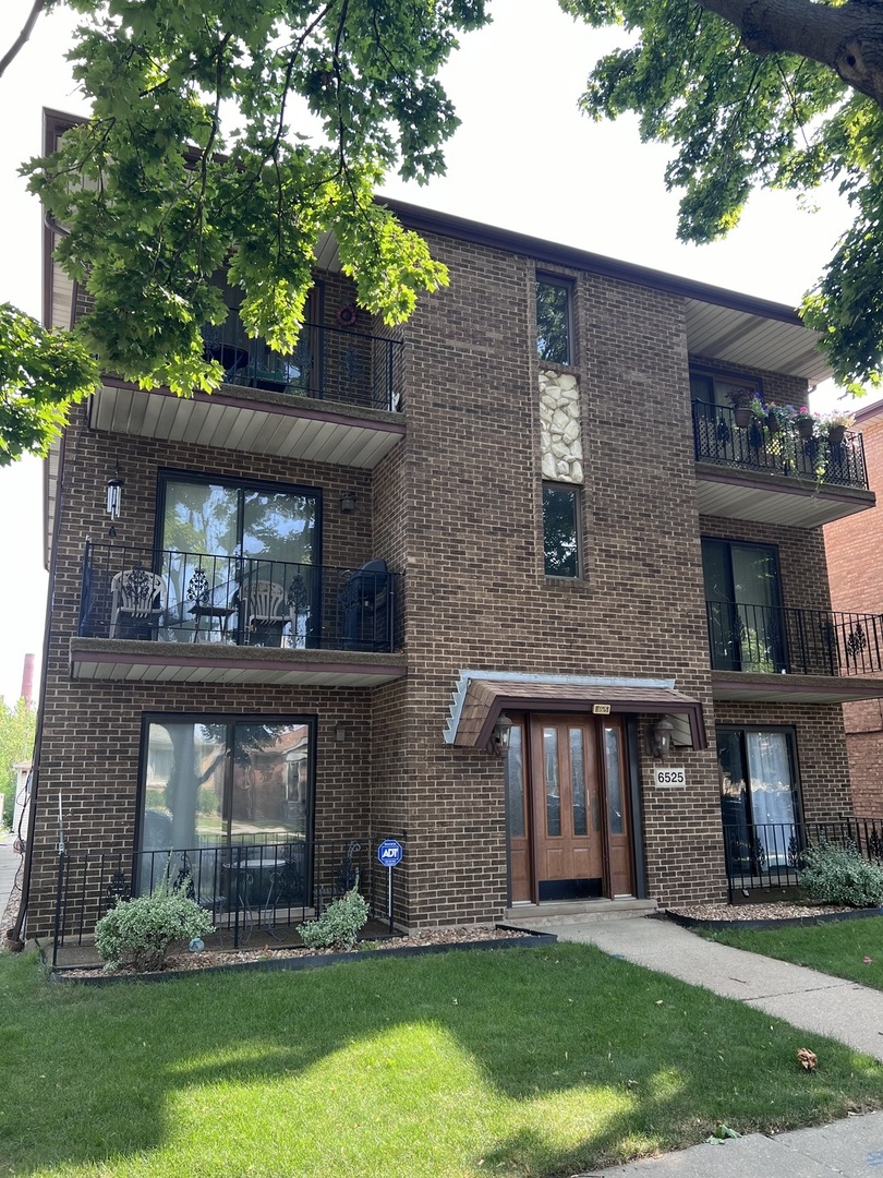 a brick building with a yard in front of it