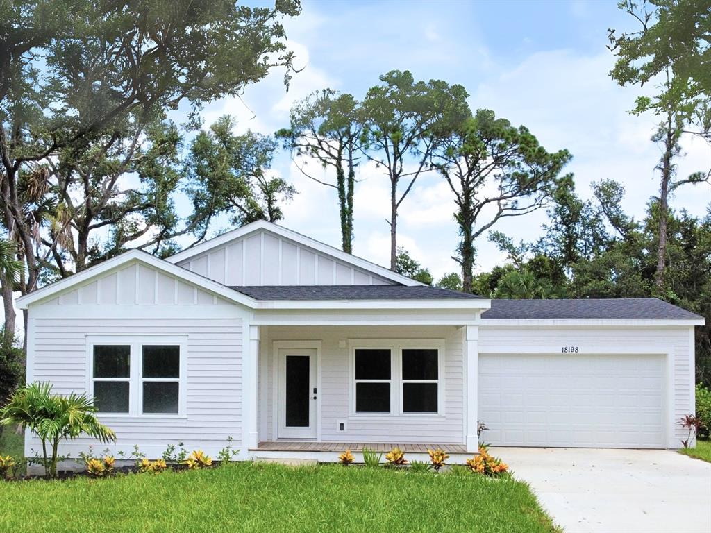 a house that has a tree in front of the house