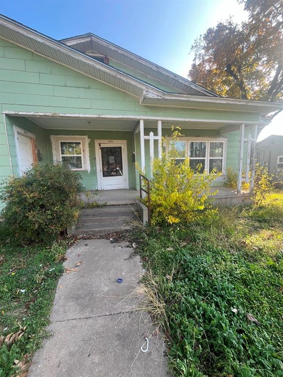 front view of house with potted plants