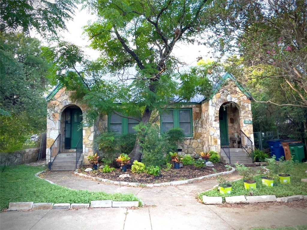 a front view of a house with garden