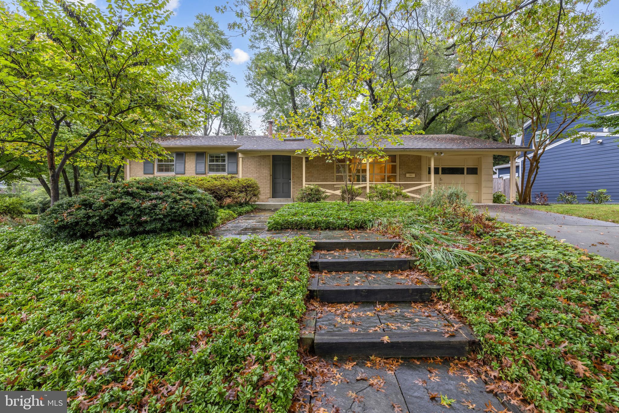 a front view of a house with a garden