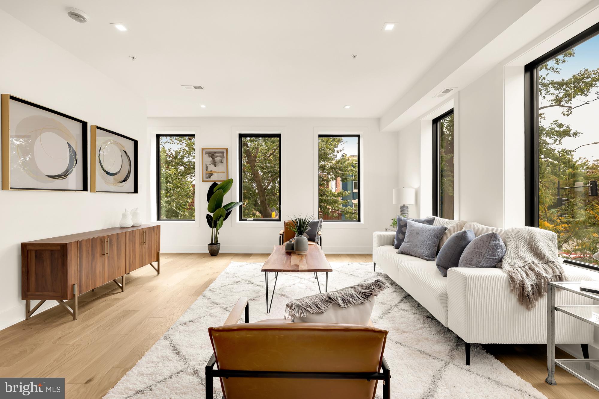 a living room with furniture and large windows