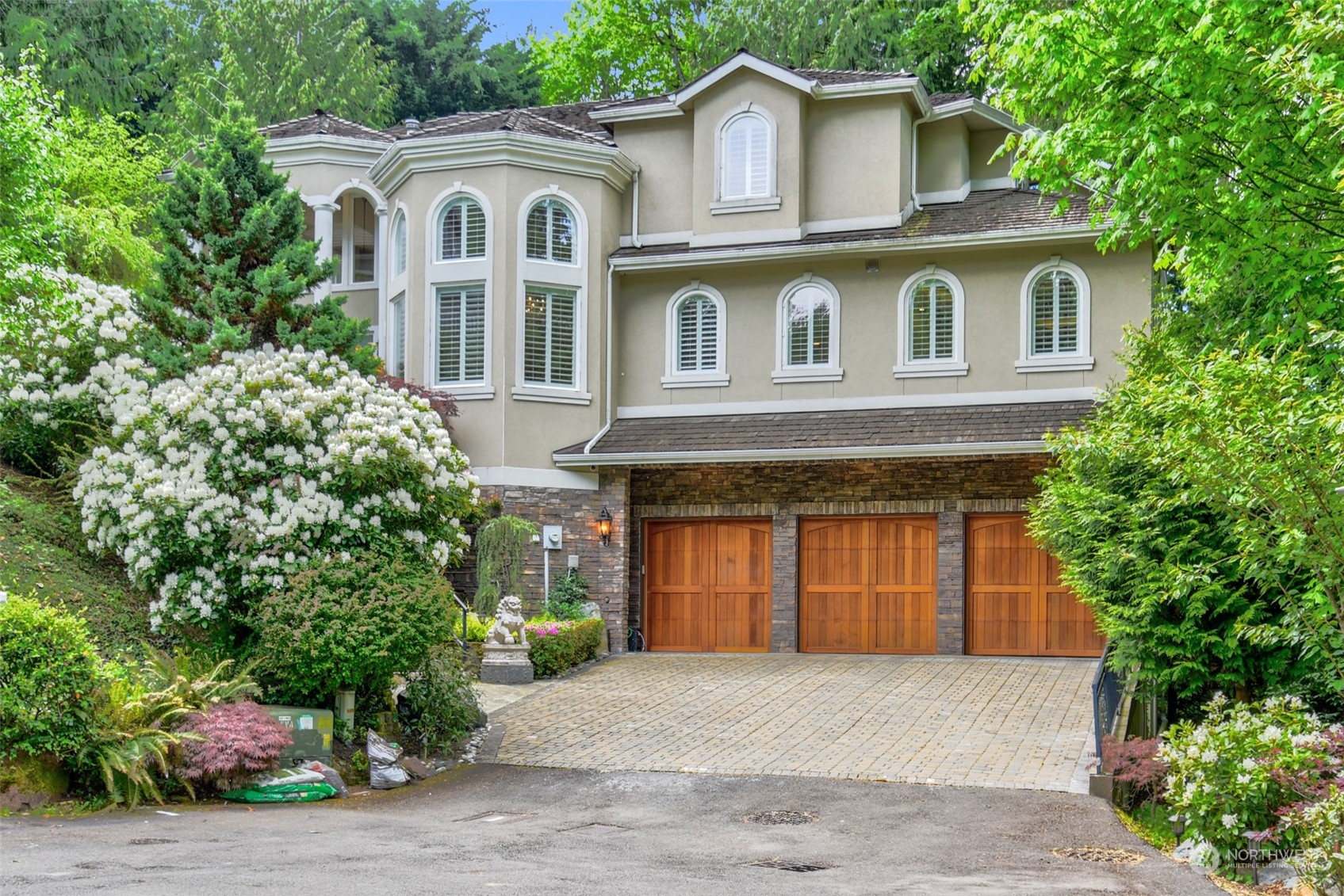 a front view of a house with a garden