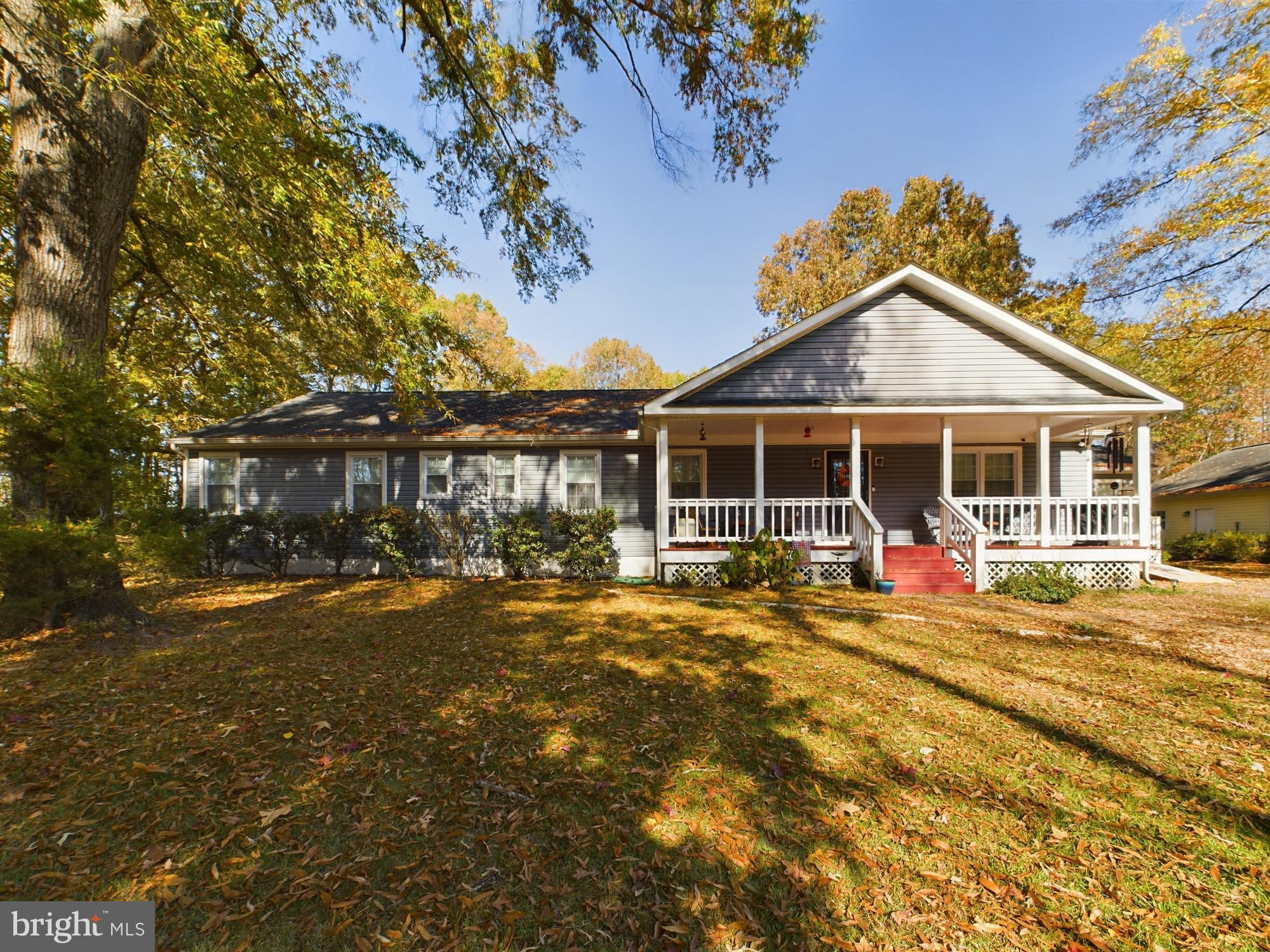 a front view of a house with outdoor seating