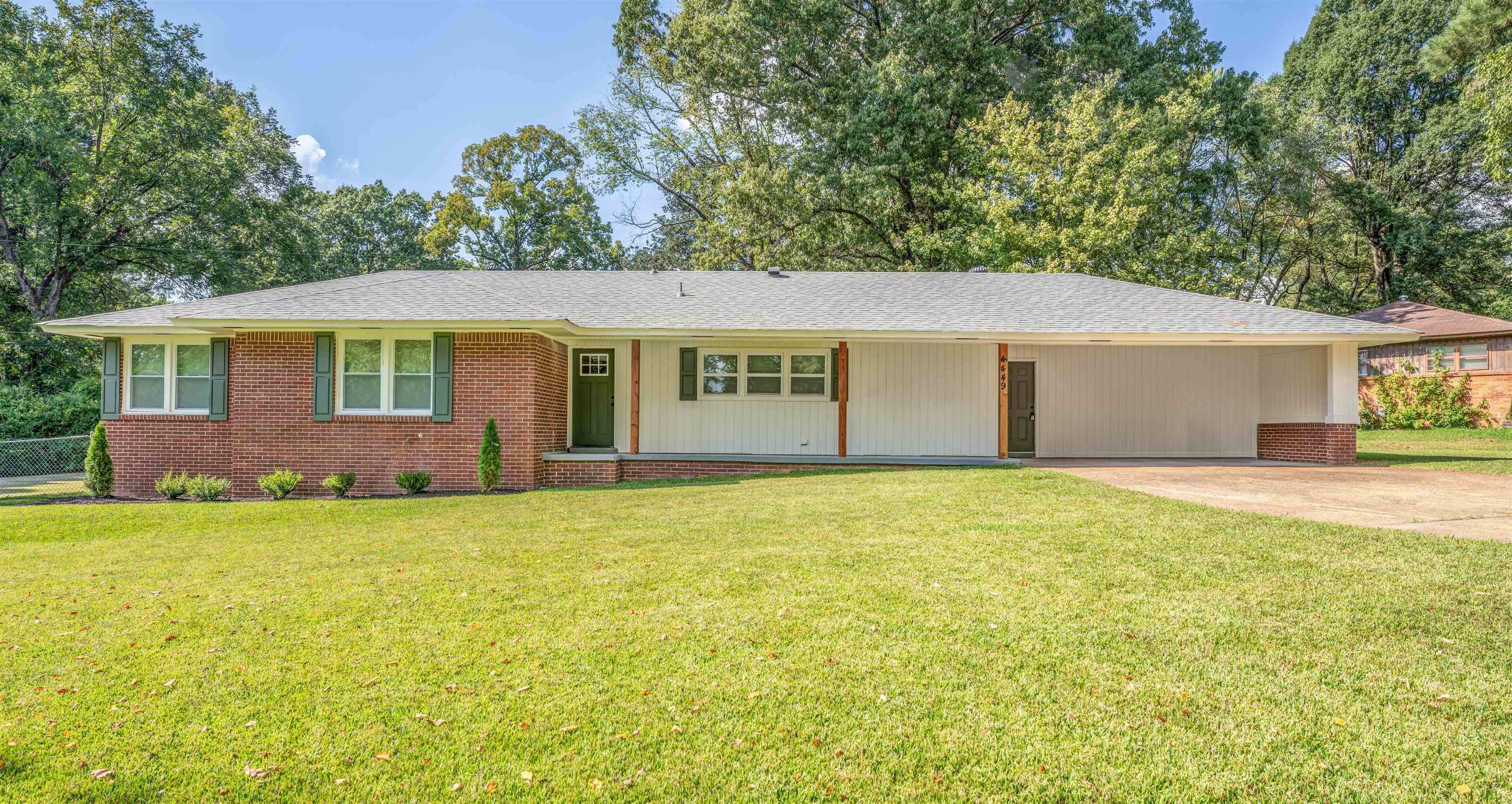 a view of a house with a yard and a garage