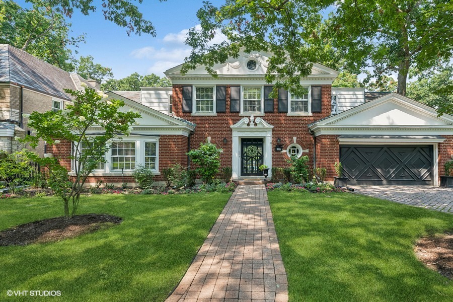 a front view of a house with a garden and porch