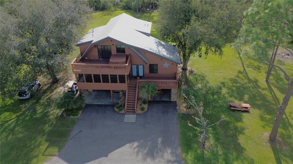 an aerial view of a house with a yard