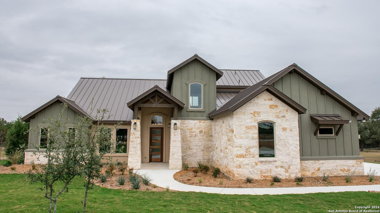 a front view of house with yard and green space