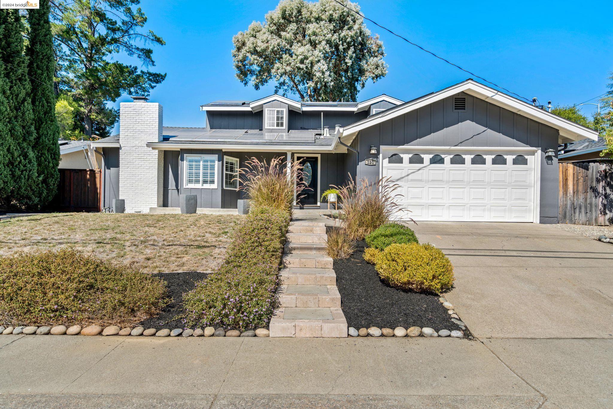 a front view of a house with garden