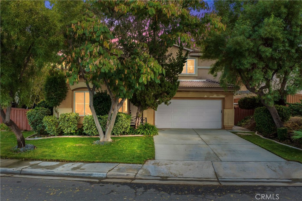 a front view of a house with a yard and a garage