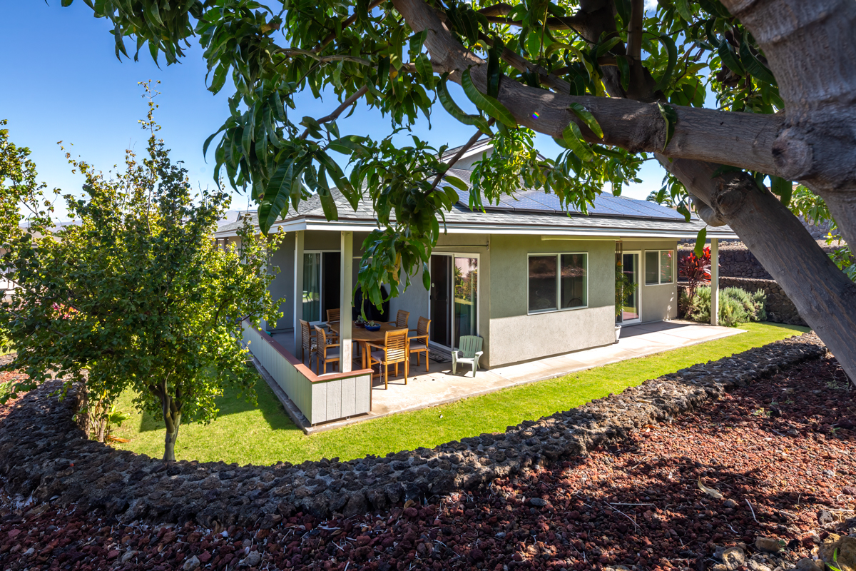 a view of a house with backyard porch and sitting area