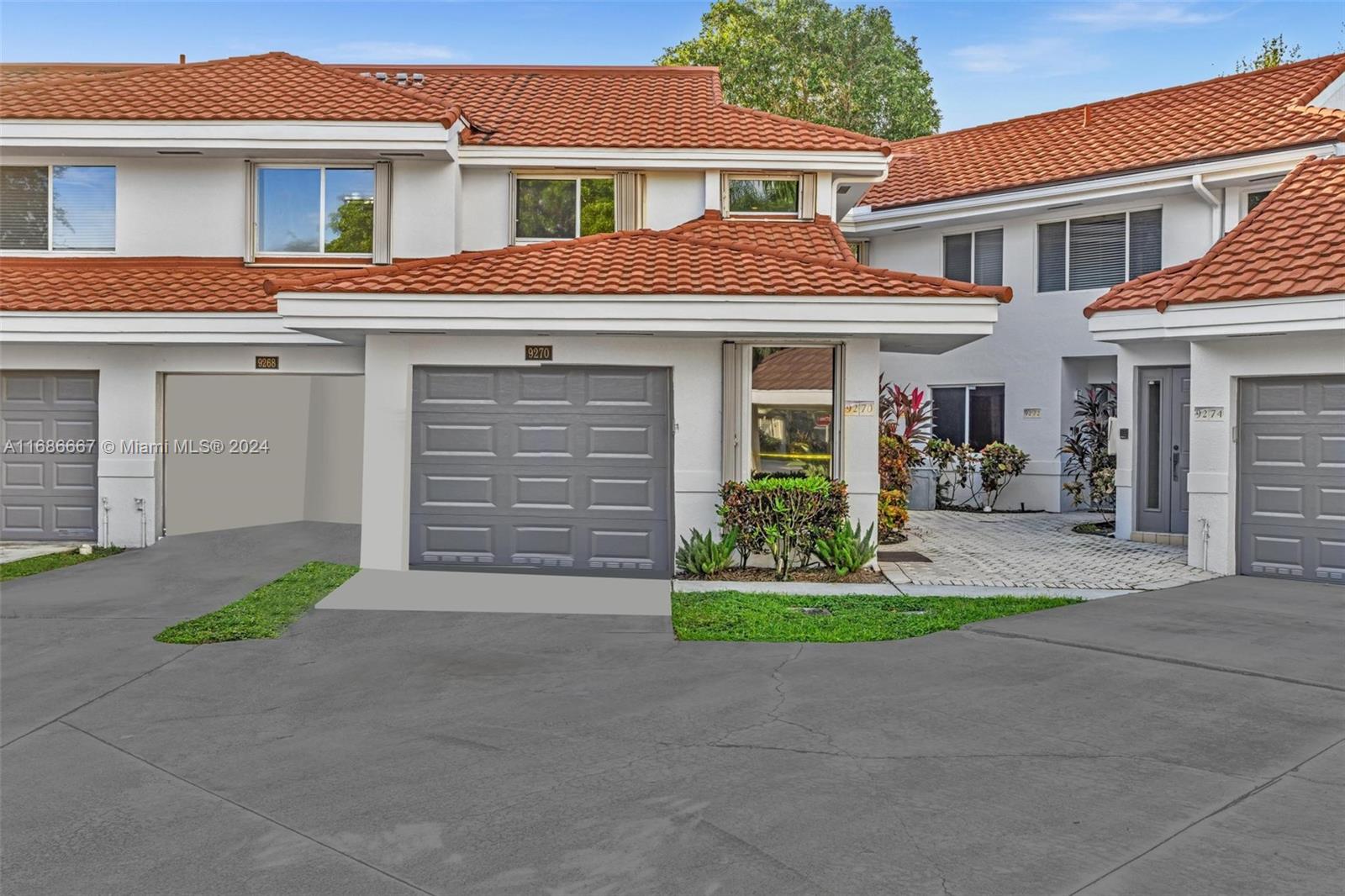 a front view of a house with a garden and yard