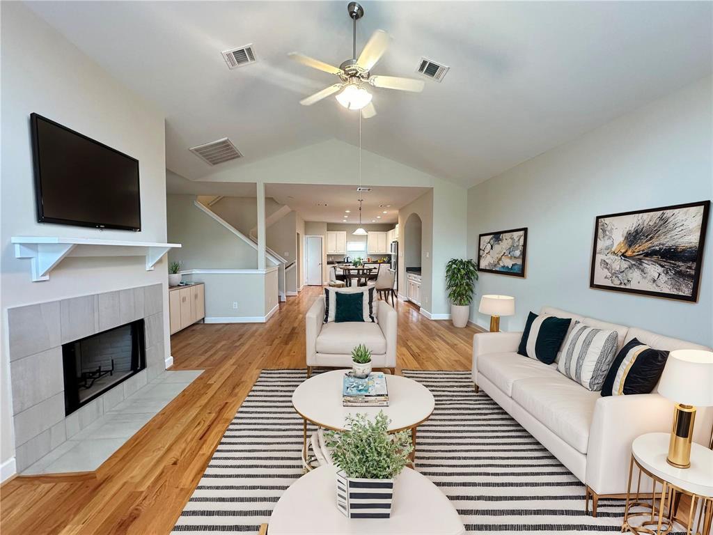 a living room with furniture a fireplace and a flat screen tv