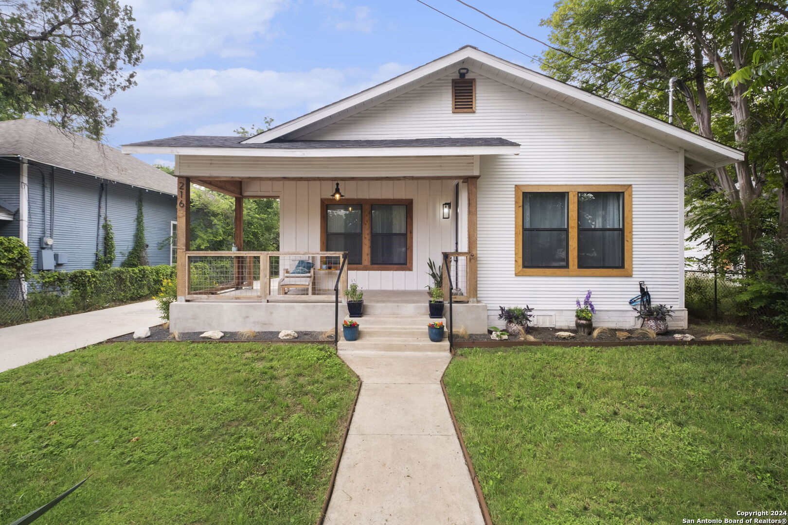 a front view of a house with a yard and porch