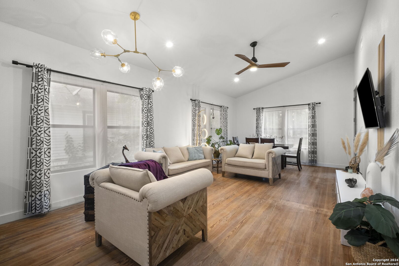 a living room with furniture and a flat screen tv