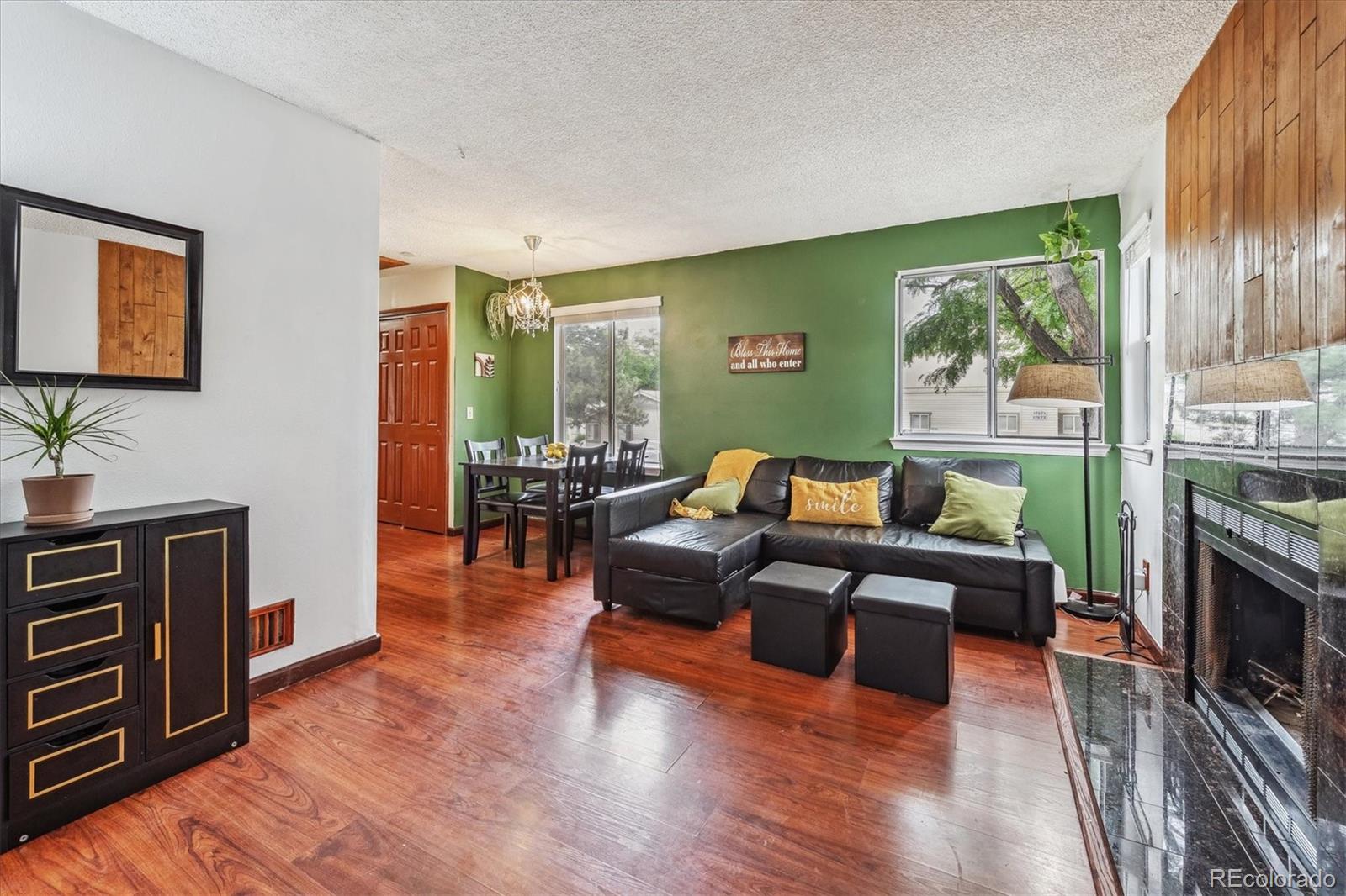 a living room with furniture and a fireplace