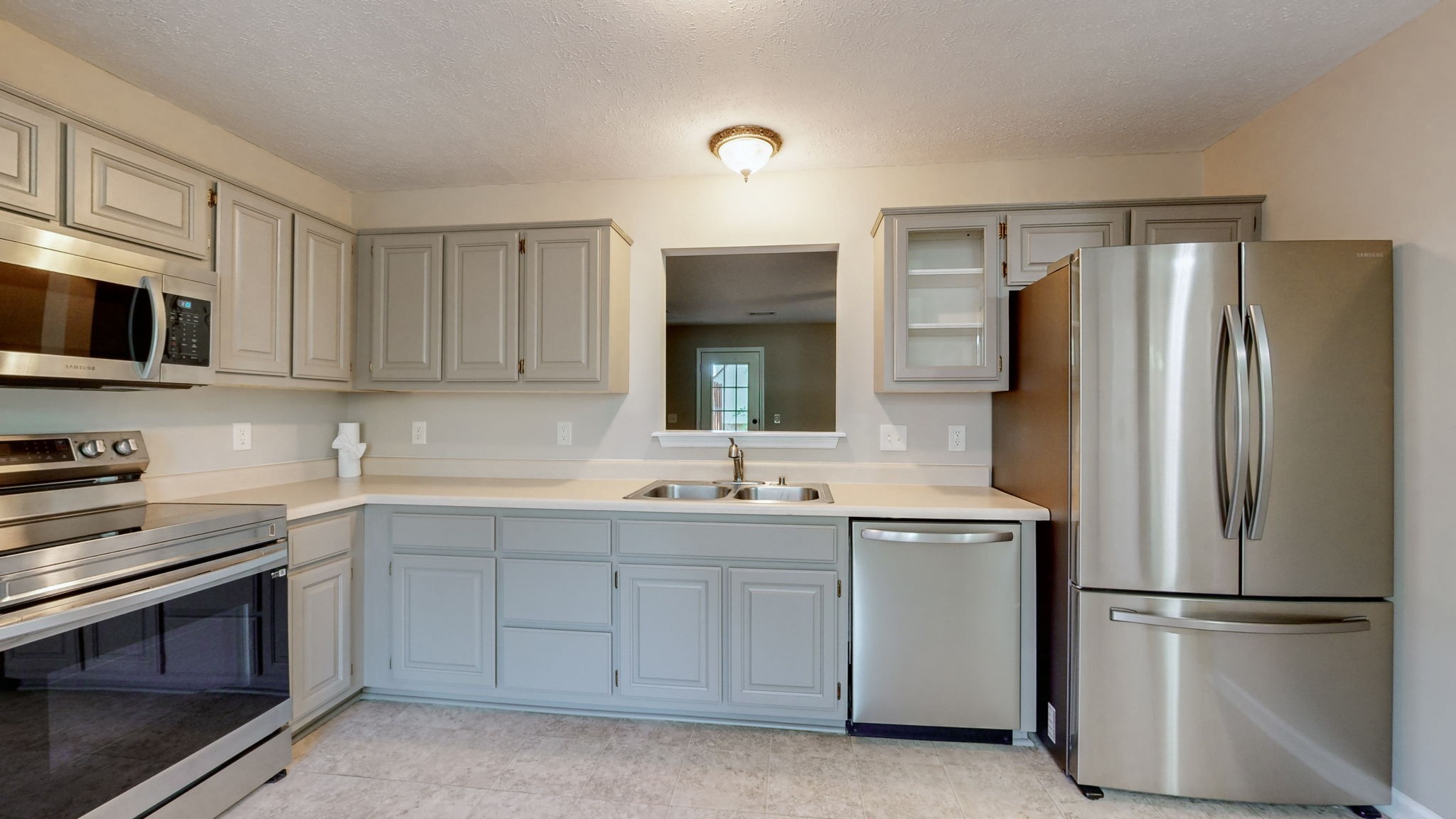 a kitchen with a sink stove and refrigerator