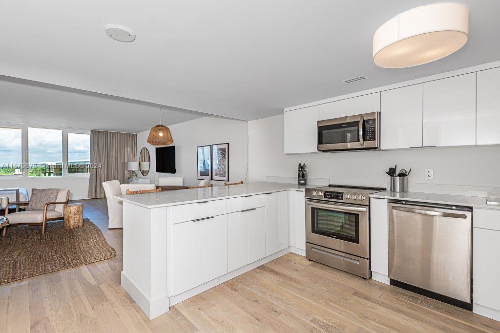 a kitchen with a sink stove and microwave