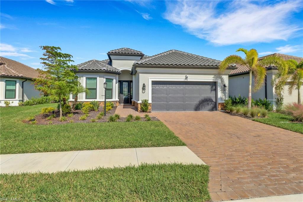 Mediterranean / spanish house featuring a garage and a front yard