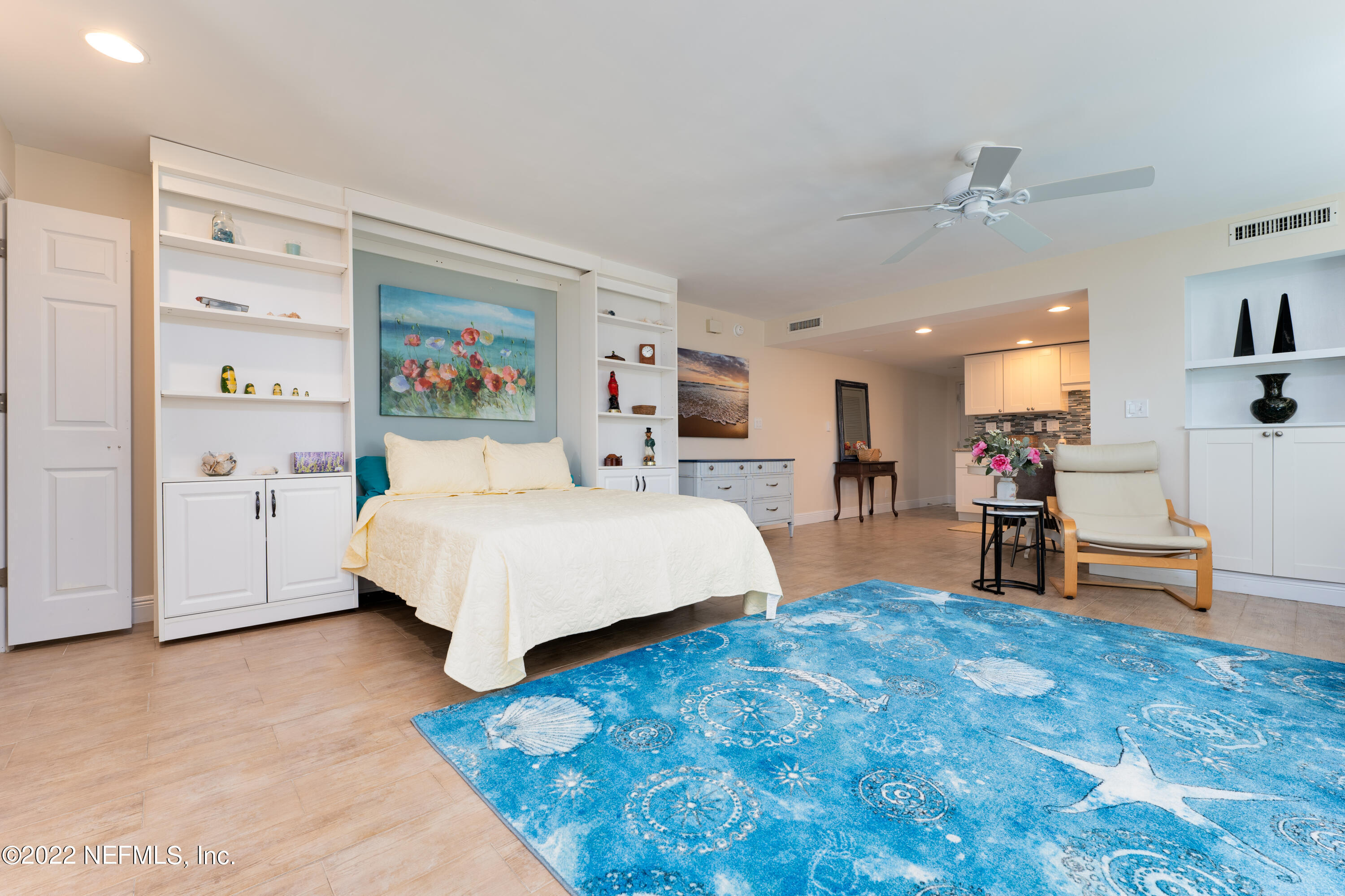 a bedroom with a bed and a view of kitchen