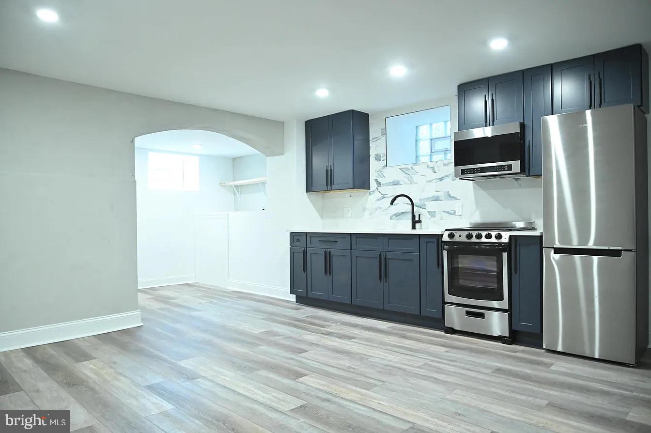 a kitchen with stainless steel appliances granite countertop a refrigerator and a sink