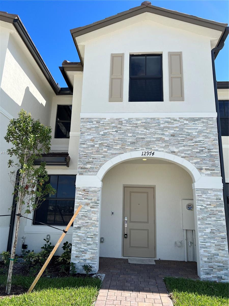 a front view of a house with garage