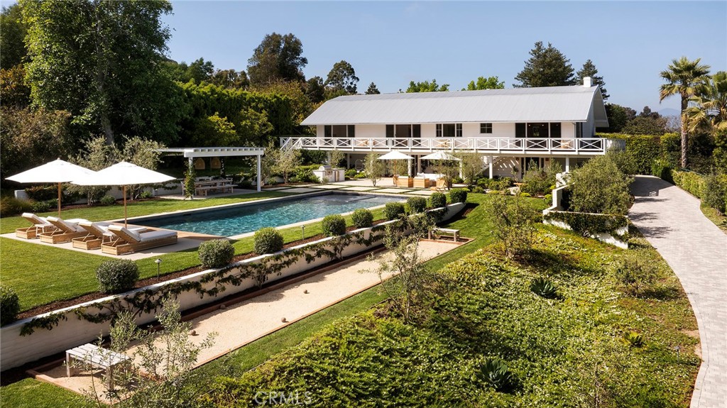 an aerial view of a house with swimming pool patio and lake view