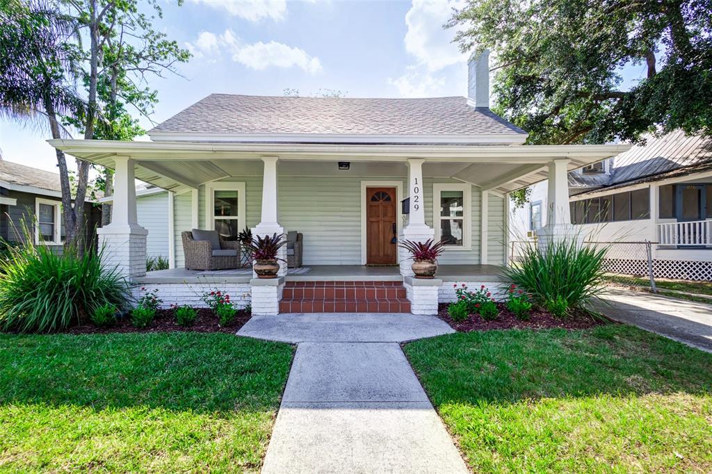 a front view of a house with yard and green space