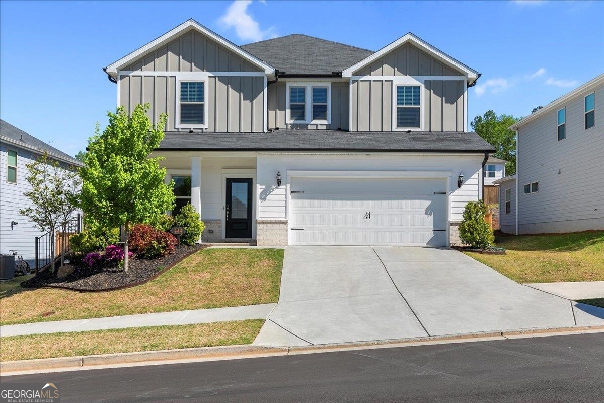 a front view of a house with a yard and garage