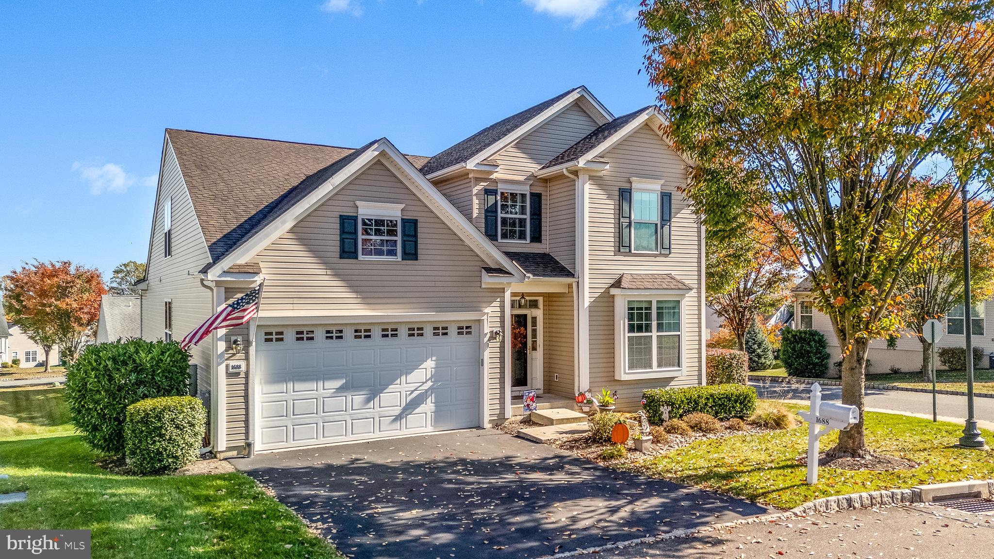 a front view of a house with a yard garage and outdoor seating