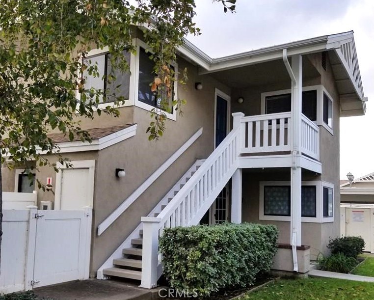 a view of house with front door and deck