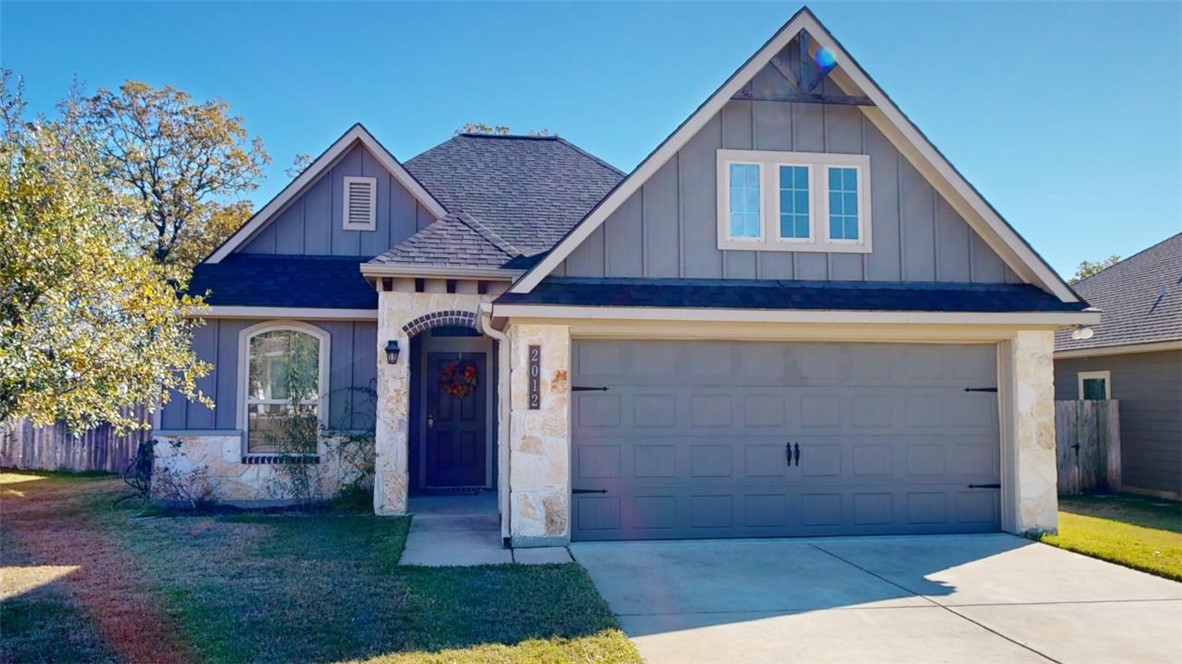 Craftsman inspired home with a garage and a front