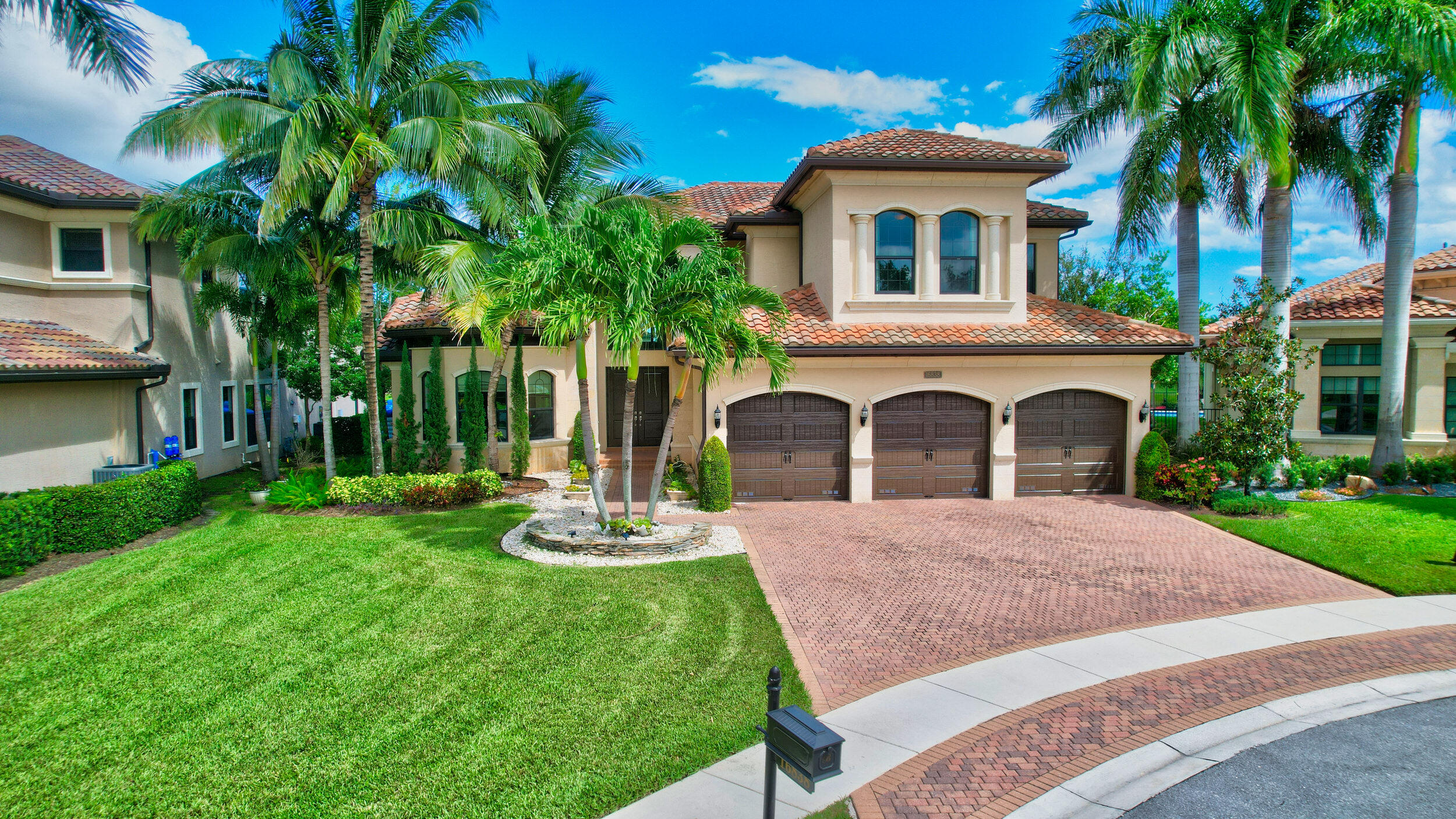 a front view of a house with a garden and plants