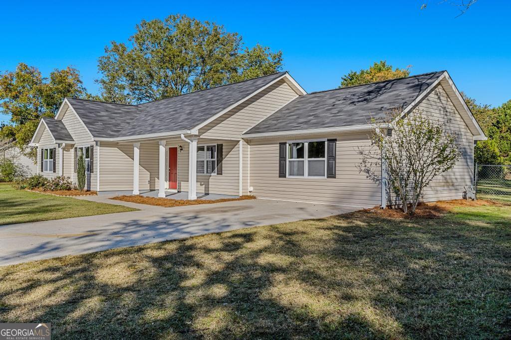 a house that has a tree in front of it