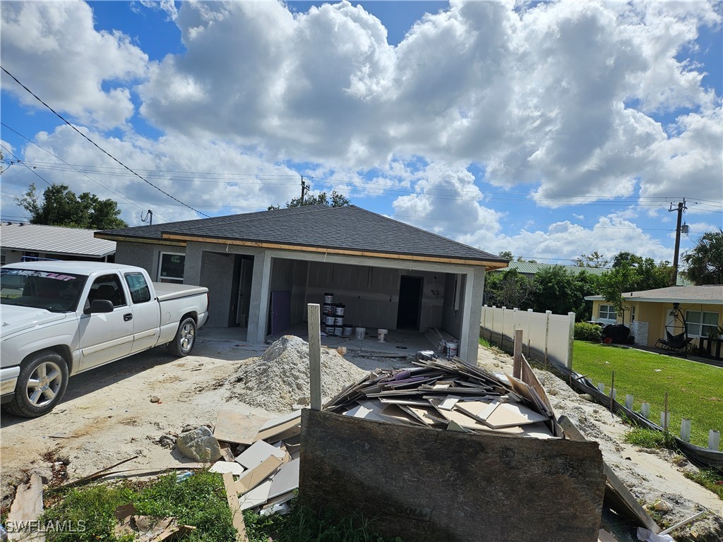 a front view of a house with cars parked