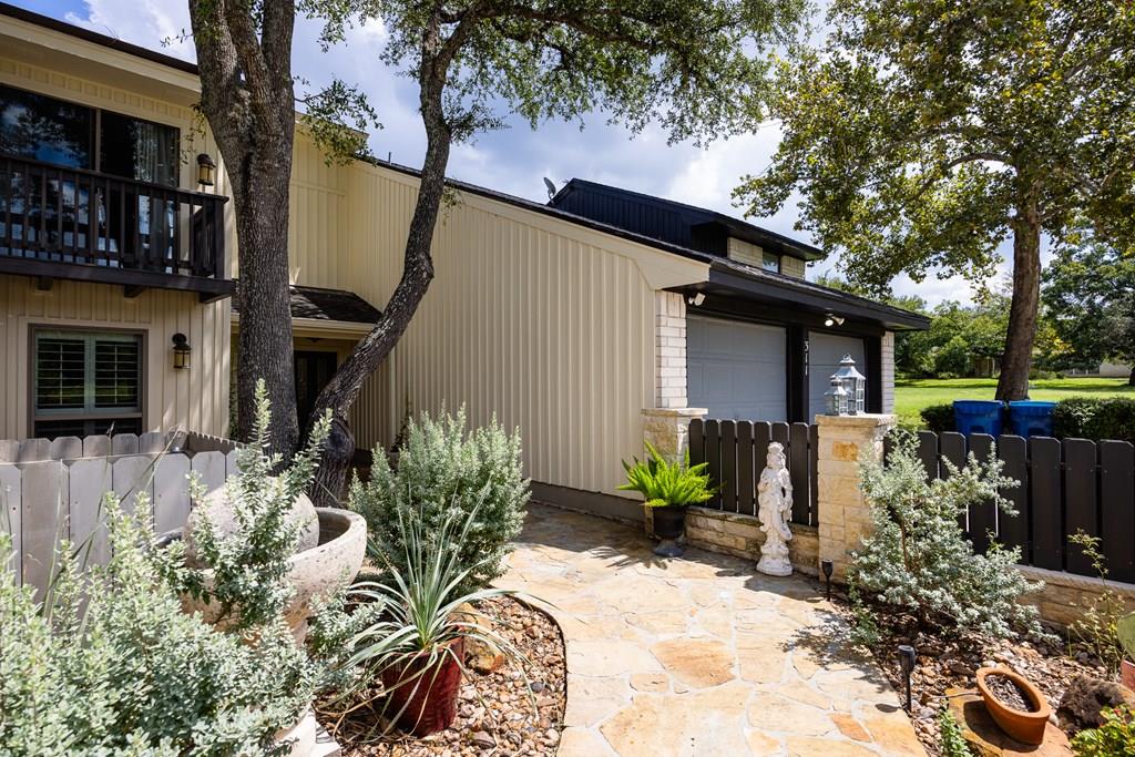 a view of a house with a yard and sitting area