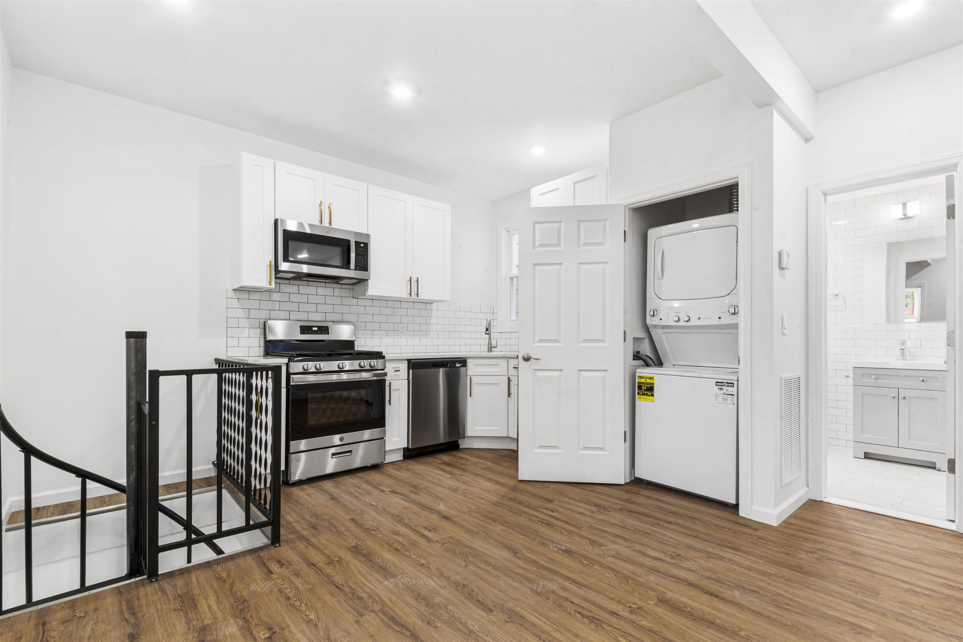 a kitchen with granite countertop a refrigerator and a stove top oven