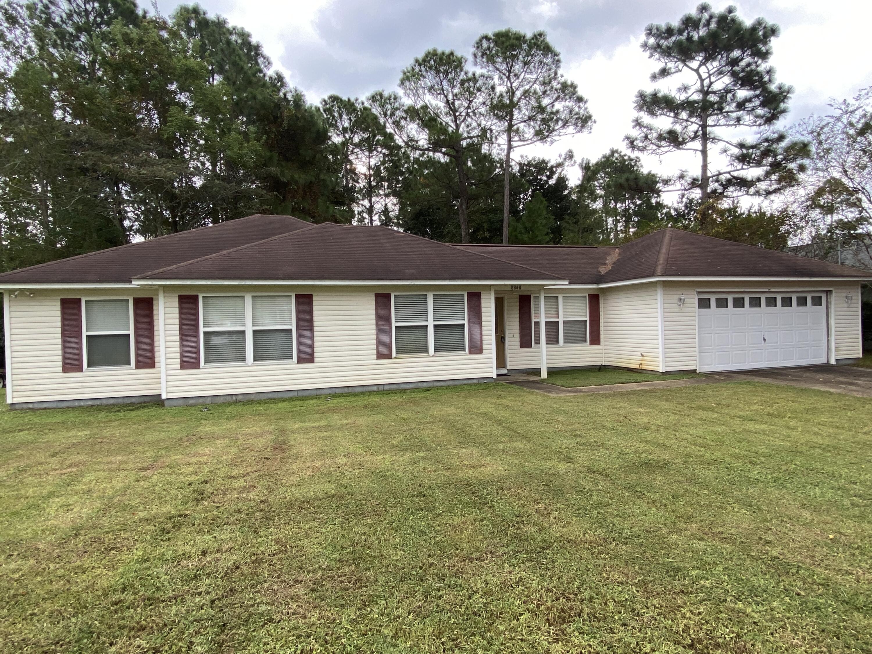 a view of a house with a backyard