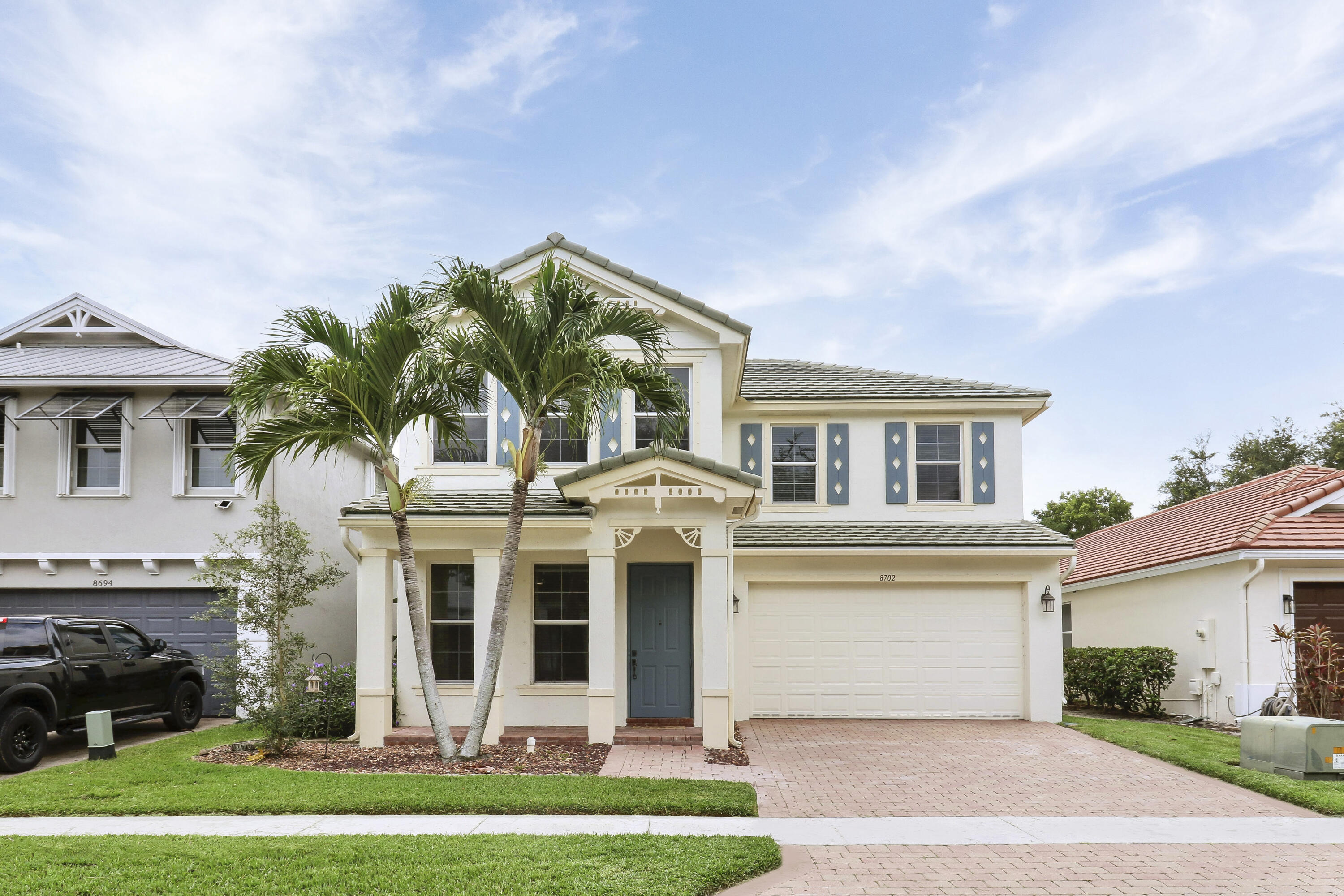 a front view of house with yard and green space