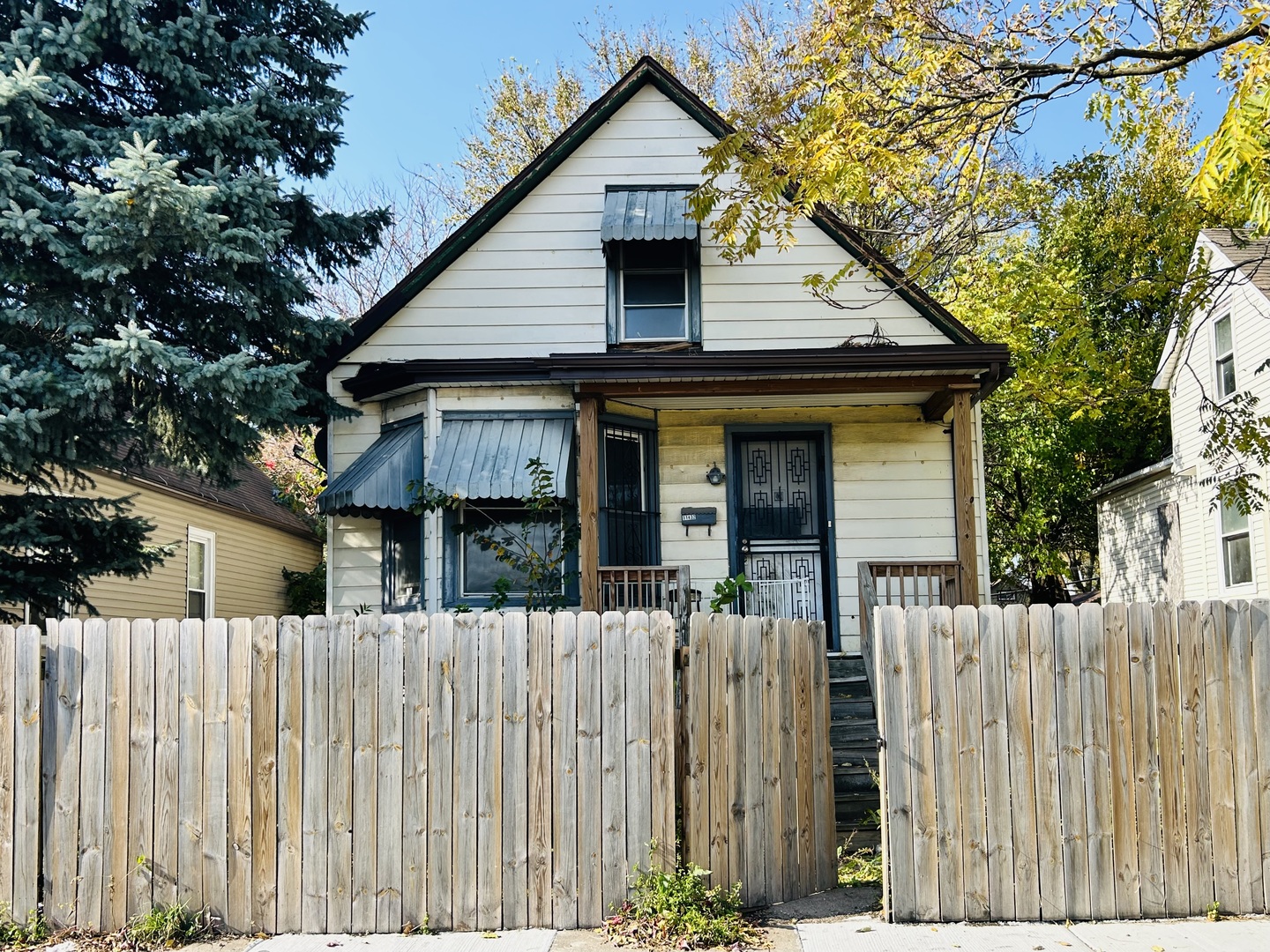 a front view of house with wooden fence