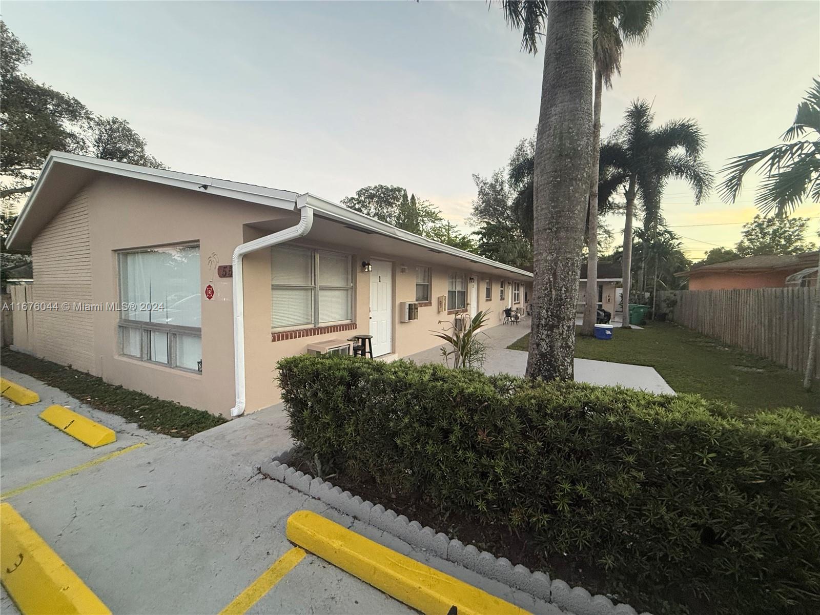 a front view of house with yard and trees around