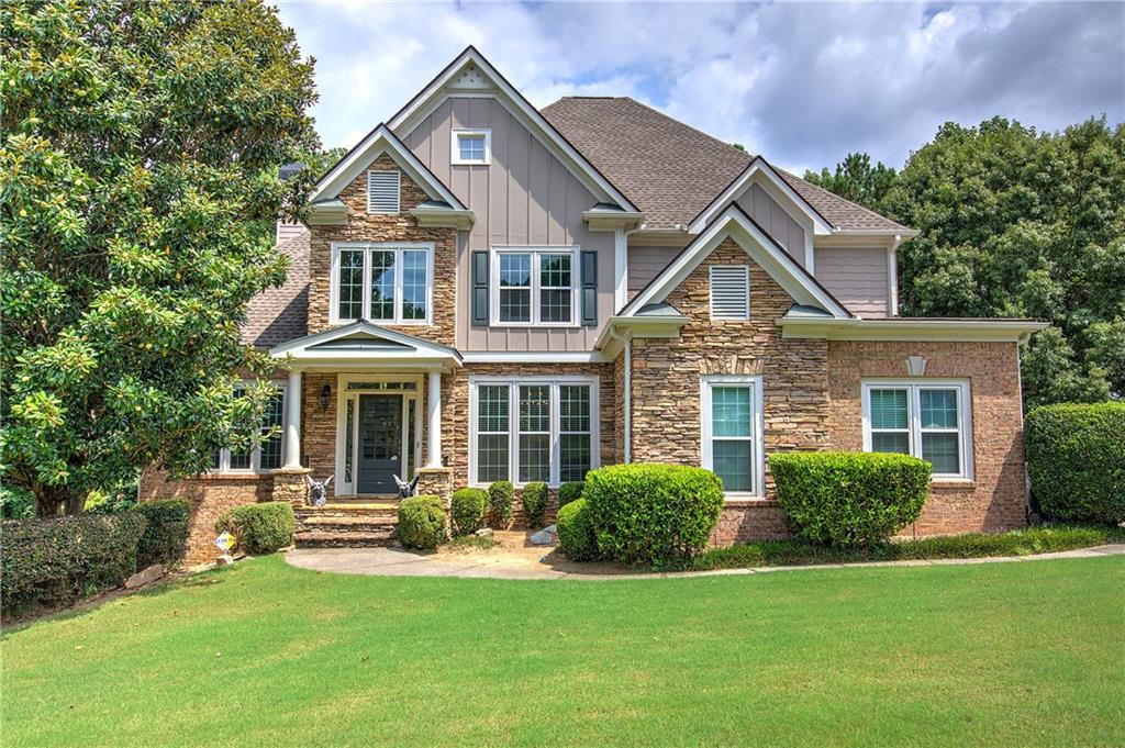 a front view of a house with a yard