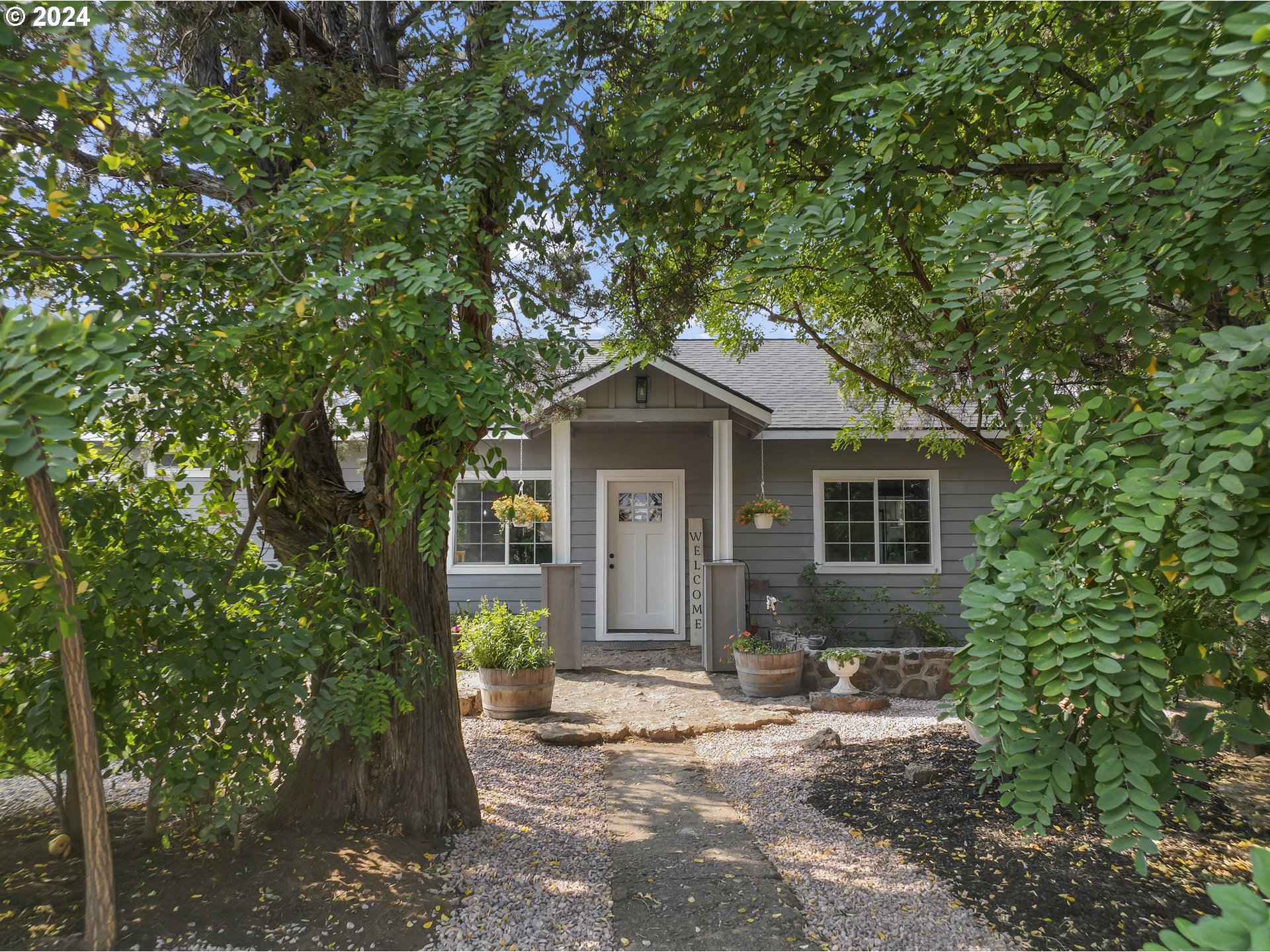 a front view of a house with garden