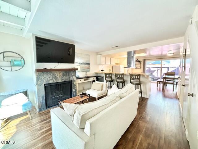 a living room with furniture fireplace and flat screen tv