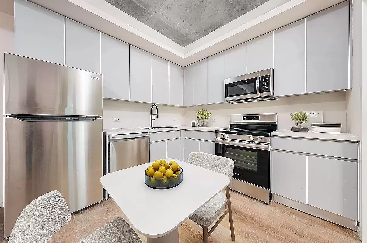 a kitchen with a white cabinets and white appliances