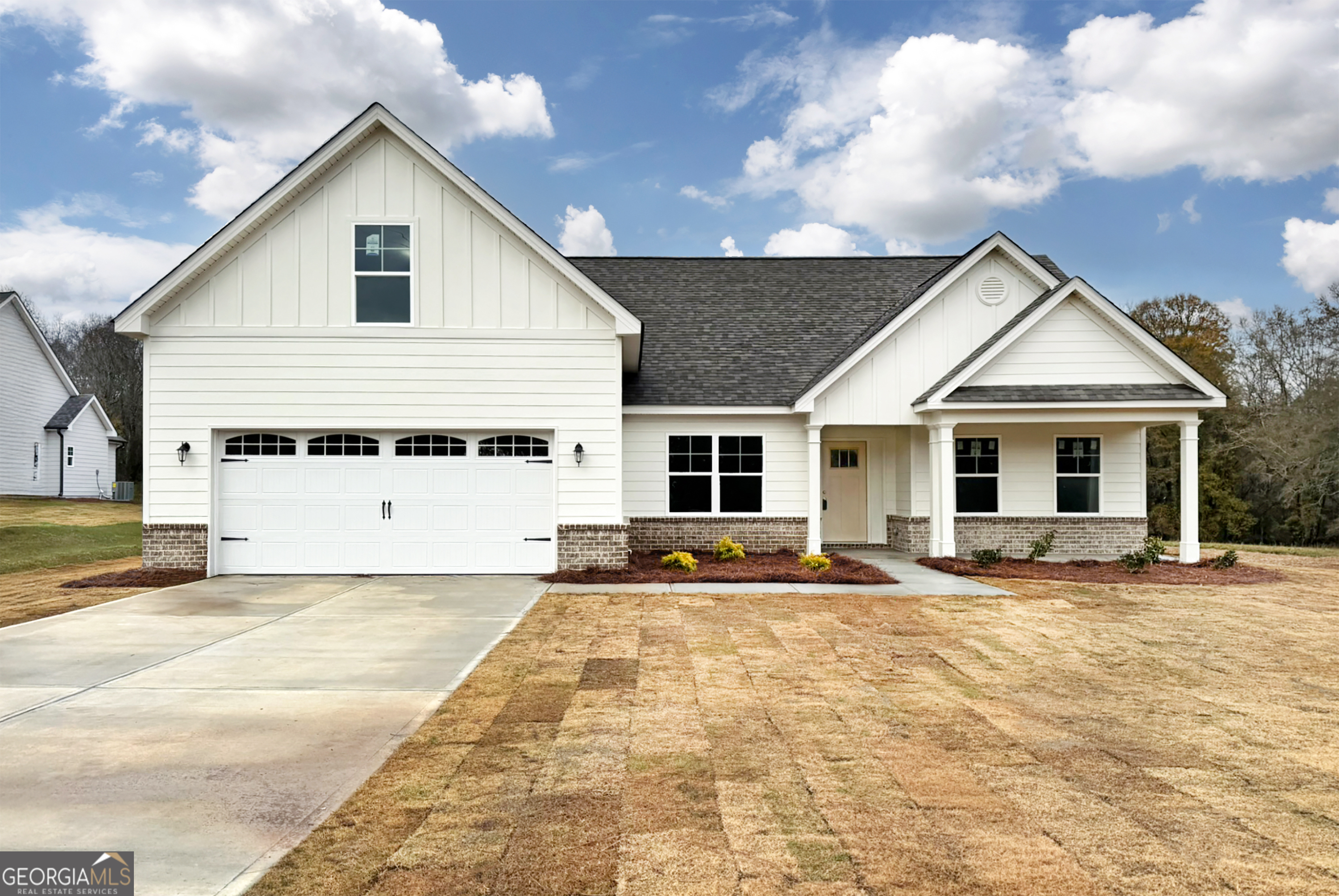 a front view of a house with trees in the background