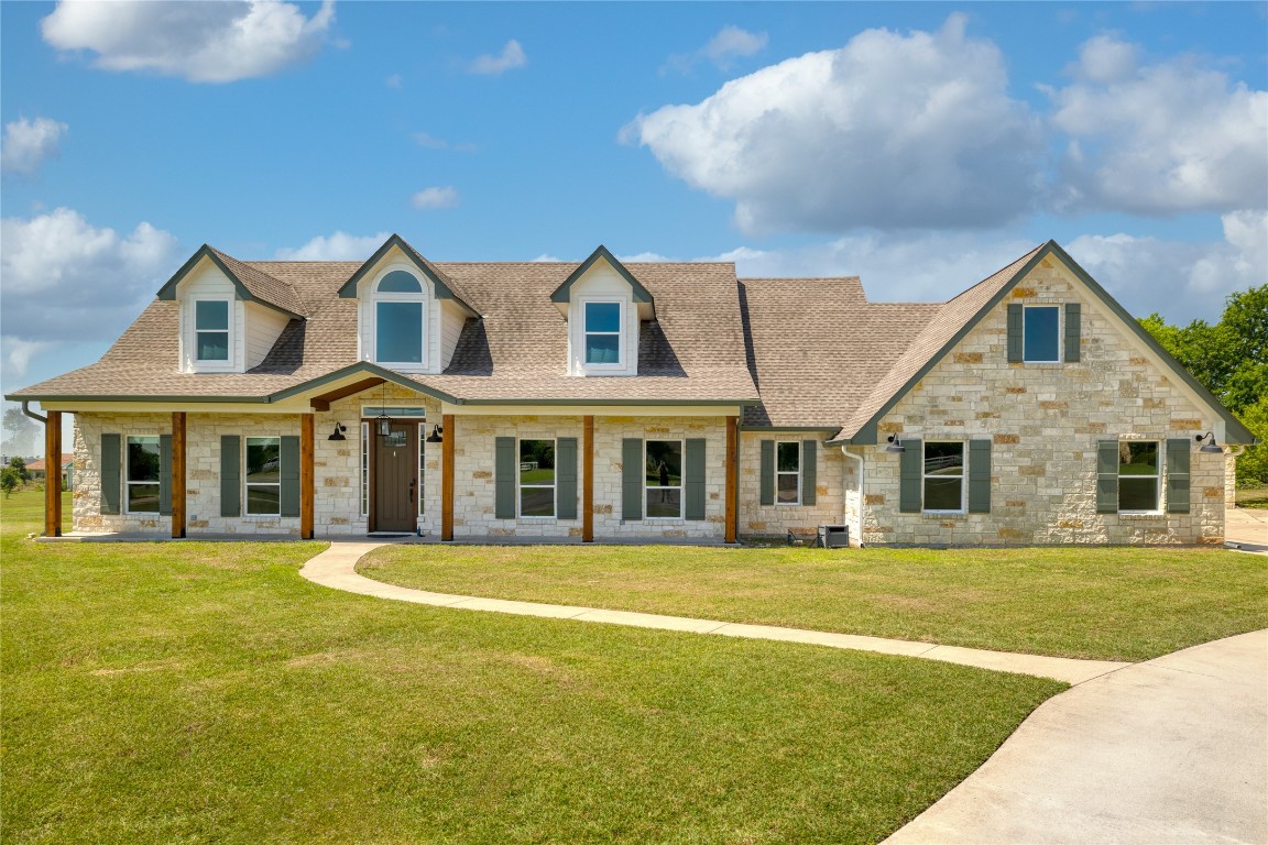 a front view of a house with a yard