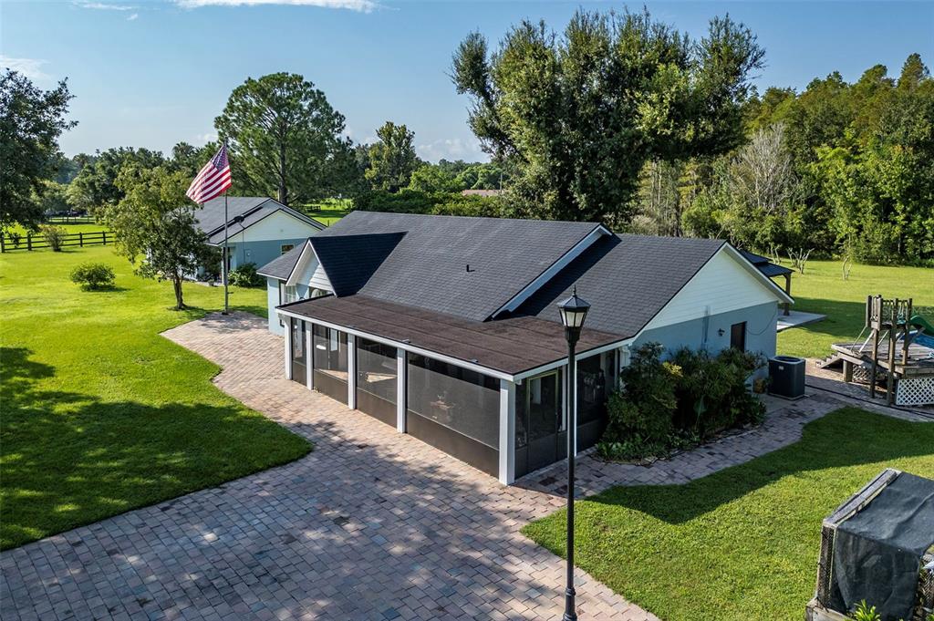 a house with green field in front of it