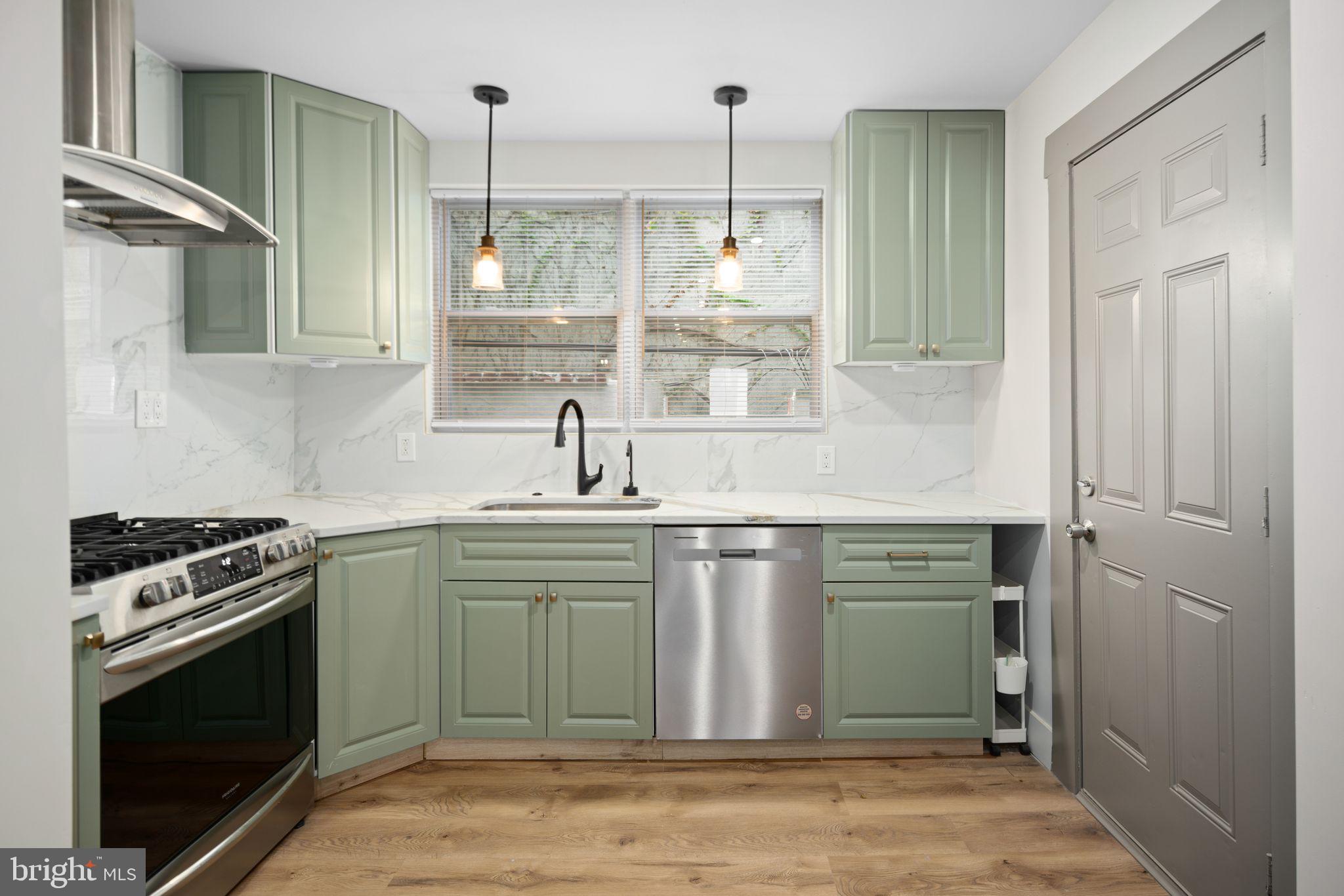 a kitchen with kitchen island a sink stove and refrigerator